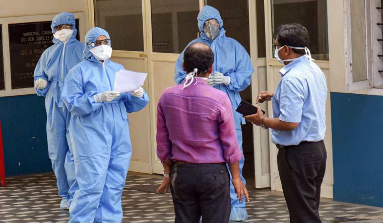 Medics wearing protective suits outside an isolation ward, set up in view of coronavirus pandemic, at Aluva Government General Hospital in Kochi | PTI