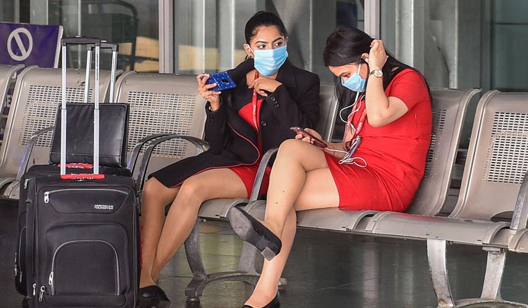  Flight attendants and ground staff wear protective face masks in wake of novel coronavirus pandemic, at NSCBI Airport in Kolkata | PTI