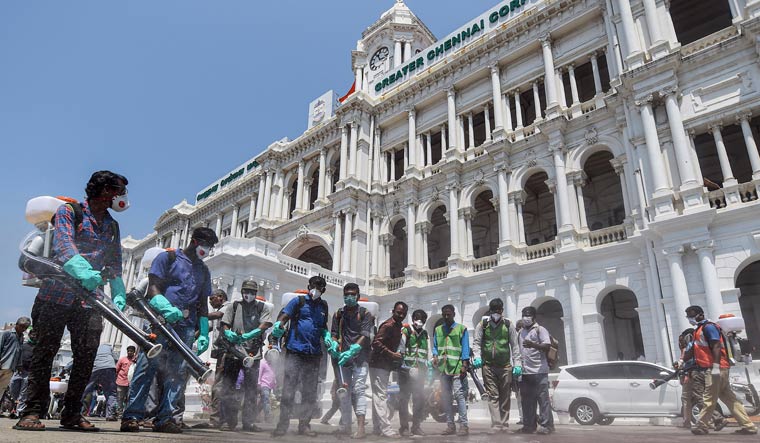 Municipal workers spray disinfectants around the building premises of Chennai Municipal Corporation | PTI