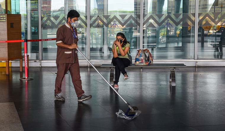 A worker sanitizes the floor as a precautionary measure to contain the spread of coronavirus, at NSCBI Airport in Kolkata | PTI