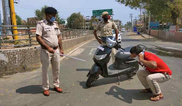 Police personal punish an offender flouting nationwide lockdown imposed by the government in the wake of coronavirus pandemic, in Hissar | PTI