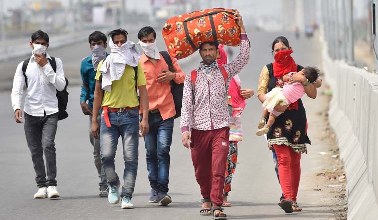 A group of migrant workers walk to their villages amid the nationwide complete lockdown, on the NH24 near Delhi-UP Border in Ghaziabad | PTI