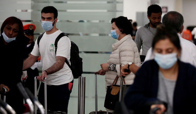 People wearing protective face masks arrive on an Emirates flight at Mexico City | Reuters