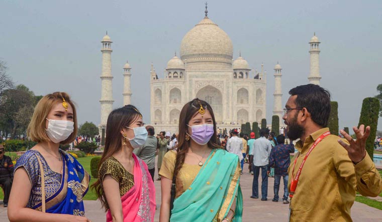 Tourist wear protective masks at Taj Mahal, in Agra | PTI