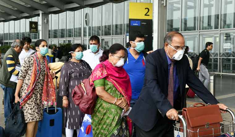 Passengers wear masks as preventive against coronavirus, at NSCBI Airport, in Kolkata | PTI