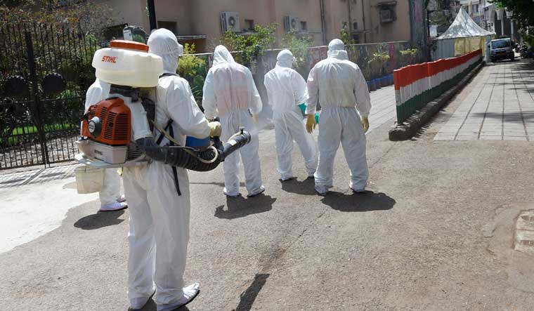 Health workers sanitise their colleagues after disinfecting an area near Nizamuddin mosque, in the wake of coronavirus pandemic, in New Delhi, Wednesday, April 1, 2020, | PTI