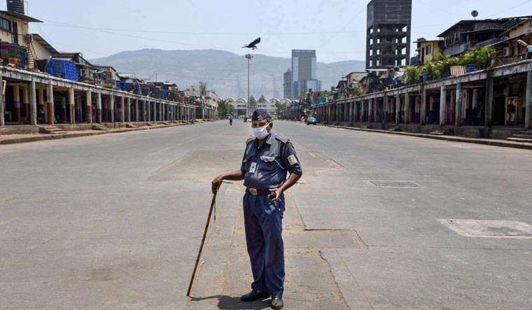 A security guard stands inside the closed APMC vegetable market in Navi Mumbai | PTI
