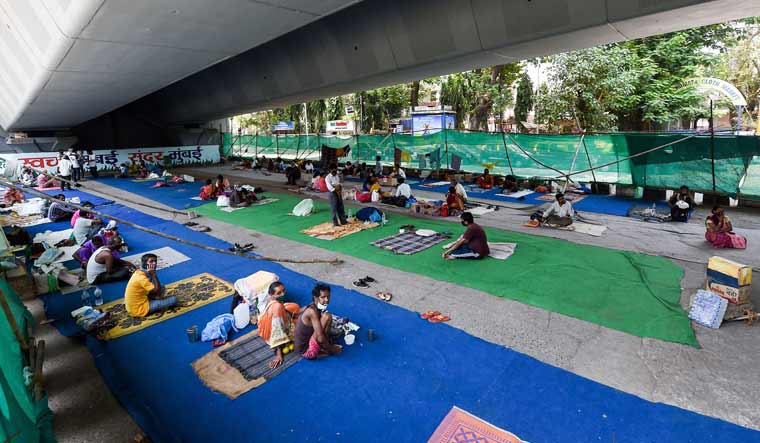 Tata Memorial Hospital patients and their bystanders were kept by the authorities under the Hindmata flyover to avoid overcrowding at the hospital, in Mumbai | PTI