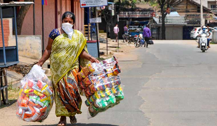 A vendor carries packed food to sell during a nationwide lockdown in the wake of coronavirus pandemic, in Chikmagalur | PTI