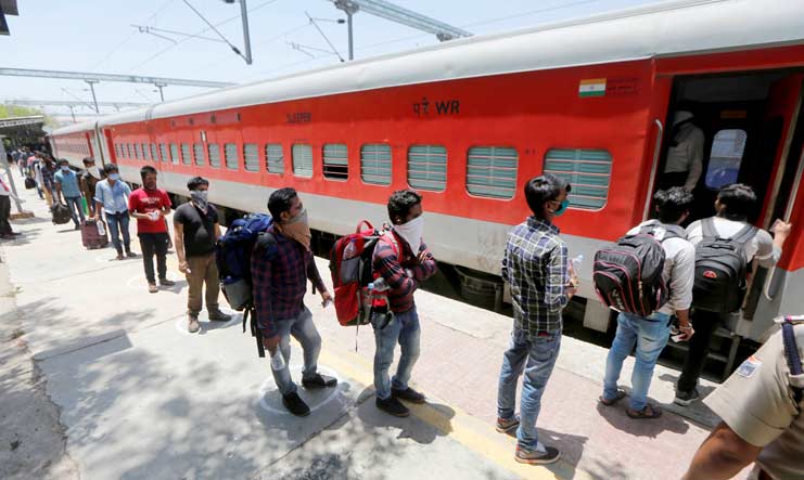 Migrants, stranded in different parts of Gujarat, boarding a special train to Odisha during the nationwide lockdown, at a railway station in Ahmedabad | PTI