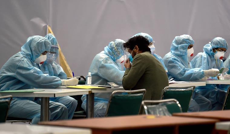 An Indian national who was stranded in Singapore amid COVID-19 pandemic, being screened by medics upon arrival at IGI Airport in New Delhi, Friday, May 8, 2020 | PTI