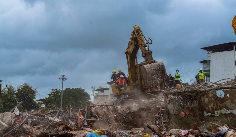 Rescuers work amidst the rubble of the five-story building that collapsed in Mahad in Maharashtra on Monday | AP