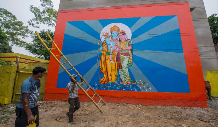 Workers paint the streets as part of preparations for the groundbreaking ceremony of a temple to the Hindu god Ram in Ayodhya, Uttar Pradesh state, India, Sunday, Aug. 2, 2020. (AP Photo)
