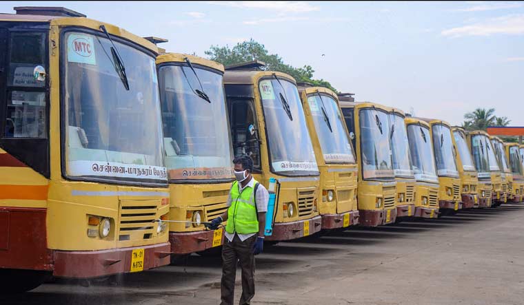 A worker sprays disinfectants after authorities allowed resumption of Metropolitan Transport Corporation (MTC) bus services  during Unlock 4, in Chennai, Monday | PTI