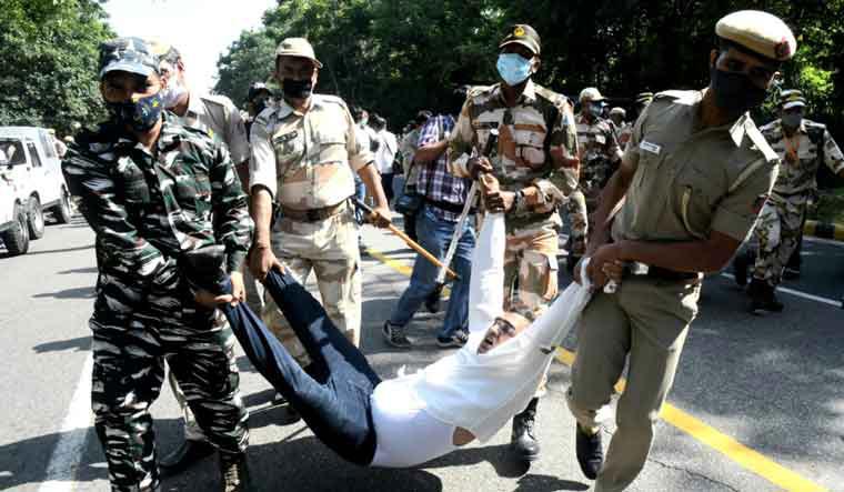 A protester is carried away by security personnel near UP Bhawan in Delhi | Aayush Goel