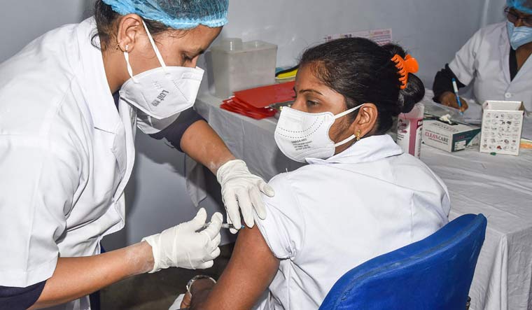 A medic administers the first dose of Covishield vaccine to a frontline worker at Gauhati Medical College Hospital in Guwahati | PTI
