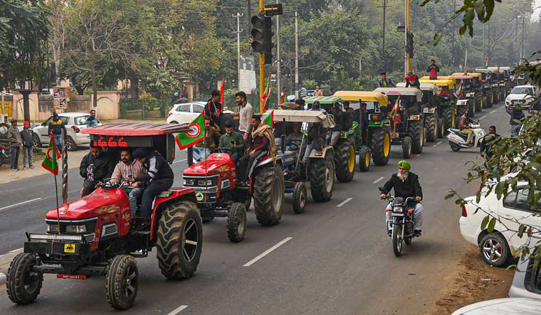 Farmers take out a tractor march as part of the preparations for their planned tractor parade in the national capital on Republic day, during a protest against the new farm laws, in Patiala | PTI