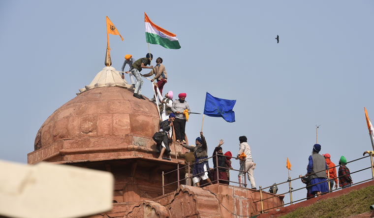 Farmers post flags on a dome of Red Fort after their tractor parade on Republic Day, in New Delhi | PTI