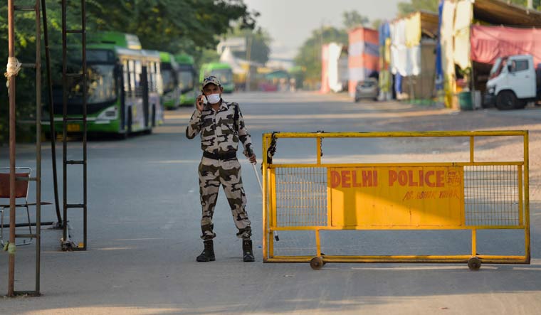 A security person keeps vigil at Singhu Border near the site of the farmers' protest, in New Delhi | PTI