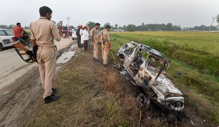 [File] Police inspect a vehicle destroyed in violence at Tikonia area of Lakhimpur Kheri | PTI