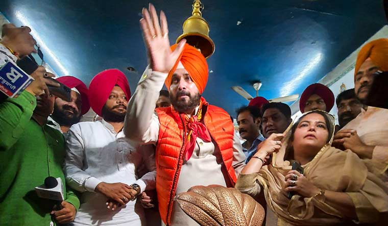 Navjot Singh Sidhu (C) offers prayer at the Ram Talai Temple | PTI