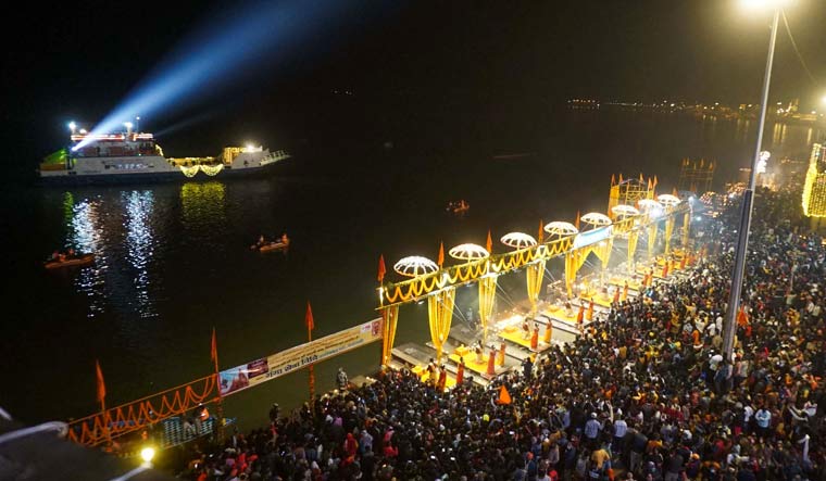 Devotees participate in the 'Ganga Aarti' as Prime Minister Narendra Modi (unseen) watches from a ship | PTI