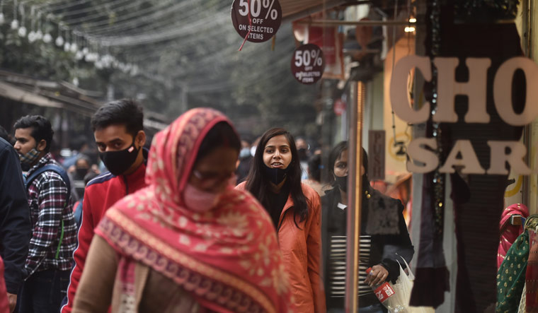 People walk in the Sarojini Nagar market amid rising cases of Omicron variant in Delhi | PTI