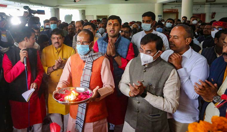 Madhya Pradesh Chief Minister Shivraj Singh Chouhan with BJP state president V.D. Sharma offers prayers during a programme organised on the death anniversary of BJP leader Kushabhau Thackeray, at the party office in Bhopal | PTI
