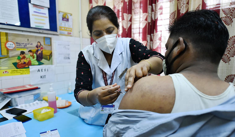 A medic administers the dose of COVID-19 vaccine to a frontline worker during an inoculation drive, at a vaccination camp in Old Delhi | PTI