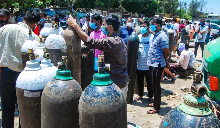 People standing outside an oxygen refill plant to refill their cylinders in Kanpur | PTI