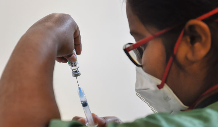 A medic prepares a dose of COVID vaccine in a syringe during a vaccination drive at Max Hospital in New Delhi | PTI