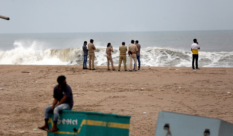 Police personnel guard near the coastline ahead of the landfall of Cyclone Tauktae, in Veraval | PTI