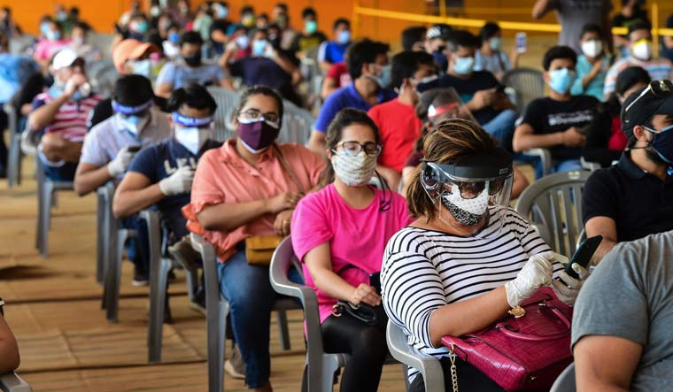 People over 18 years of age wait to receive COVID-19 vaccine doses at one of the largest vaccination sites set up by BLK-Max hospital at Radha Soami Satsang Beas grounds, in New Delhi | PTI
