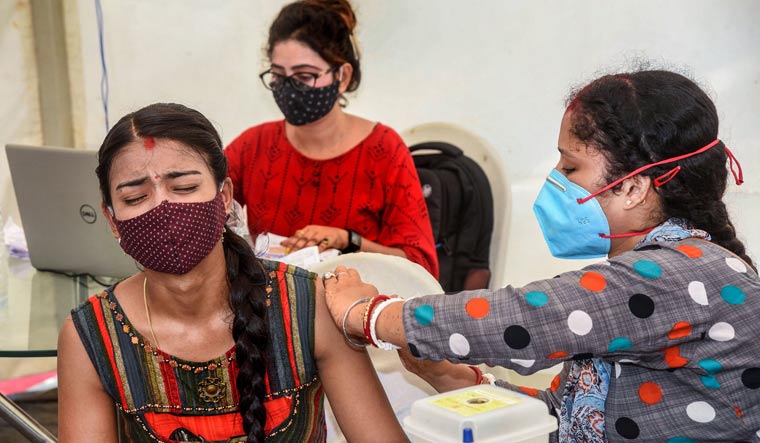 A beneficiary reacts as she receives a dose of COVID-19 vaccine, at Patliputra Sport Complex in Patna | PTI