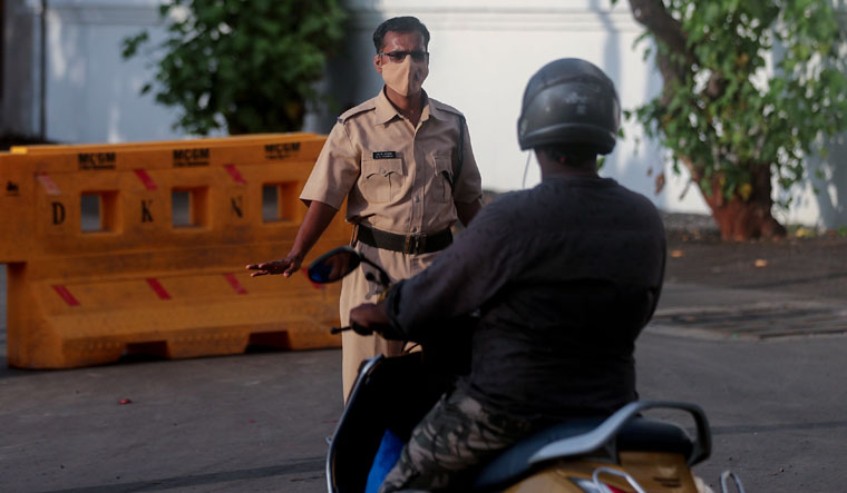 A police officer stops a motorist during a partial lockdown to curb the spread of coronavirus in Mumbai | AP