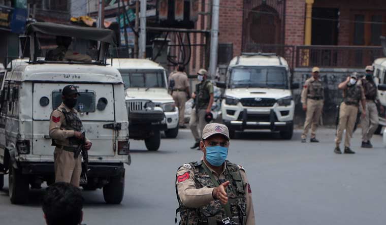 Policemen stand guard at a closed market in Srinagar | AP