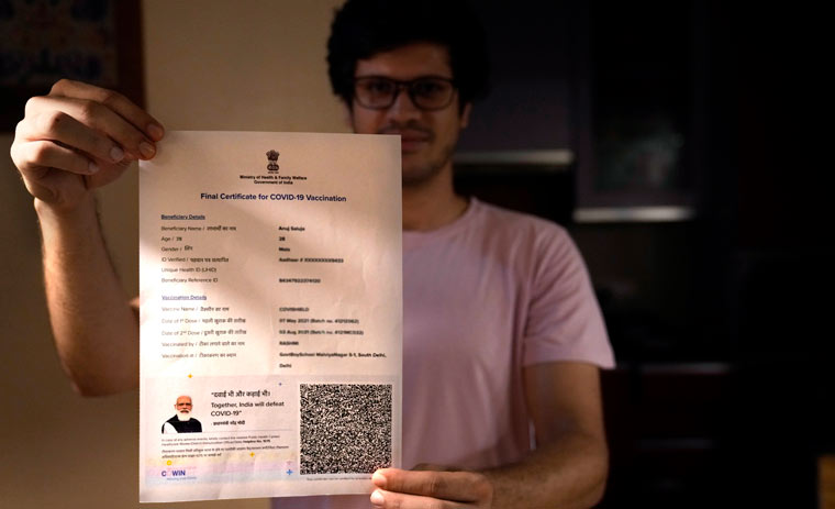 A boy displays his Covishield vaccination certificate in New Delhi | AP