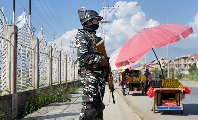 A security personnel stands guard during restrictions at Eidgah in Srinagar | PTI