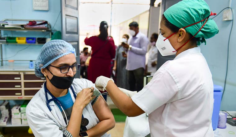 A nurse administers a booster dose of COVID-19 vaccine to a health worker in Mumbai | PTI