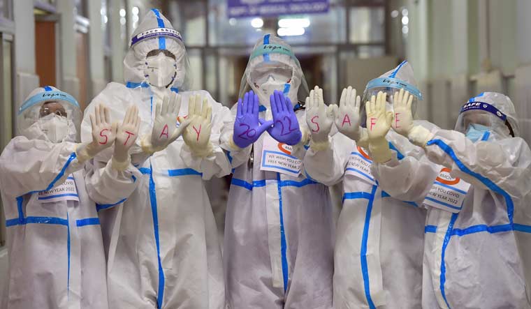Medical staff of M.S. Ramaiah hospital in Bengaluru wearing PPE and gloves pose for photographs on New Year's eve | PTI
