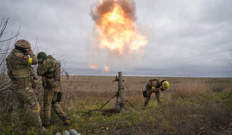 Ukrainian National Guard soldiers fire at Russian positions with a mortar near Kharkiv | AP