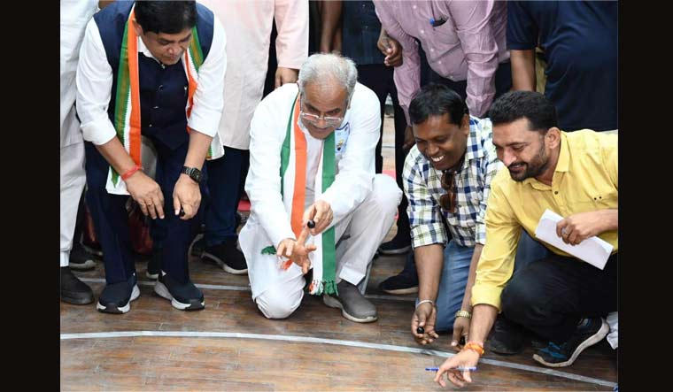 Chief minister Bhupesh Baghel plays traditional 'bati' (marbles game) after inaugurating maiden 'Chhattisgarhiya Olympics'  in Raipur on Thursday