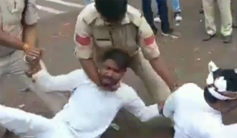 Police detain a NEYU protester during a demonstration in Bhopal | Video grab