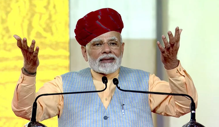 Prime Minister Narendra Modi speaks during a ceremony to lay the foundation stones of various development works at Modhera village in Mehsana district of Gujarat | PTI