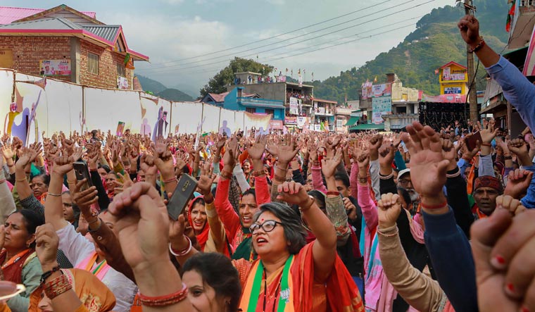 BJP supporters listen to Union Home Minister Amit Shah's address at Bhattiyat Assembly constituency | PTI