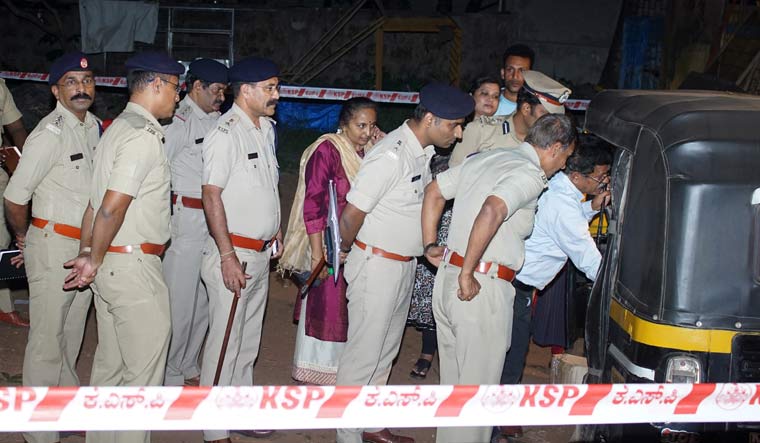 Police officials examine an auto-rickshaw after an explosion inside the vehicle in Mangaluru | PTI