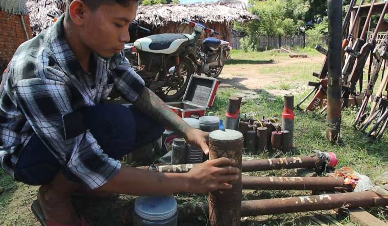 A member of  People Revolution Army (PRA) preparing homemade weapons in Pale township | AFPTV / AFP