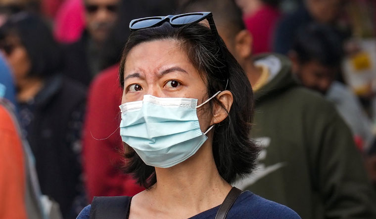 A woman wearing a face mask at Khan Market in New Delhi | PTI