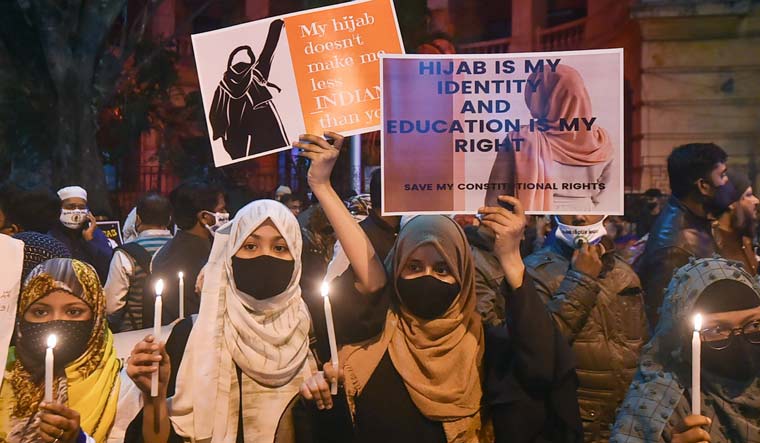 Muslim women participate in a candlelight march in Kolkata in protest over the 'hijab' controversy in Karnataka | PTI