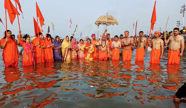 Mahamandaleshwar Swami Kushal Giri with followers take a holy dip in River Ganges | PTI